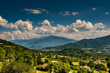 A valley near Foix in France with trees and mountains in background