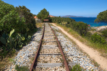 Fototapeta premium the end of a railroad near the sea