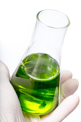 A flask for chemical analyzes with a violet liquid in hand