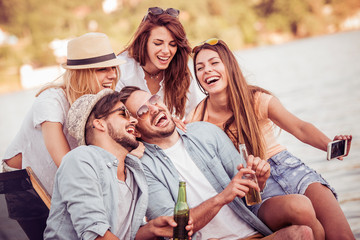 Friends taking selfie on the beach.