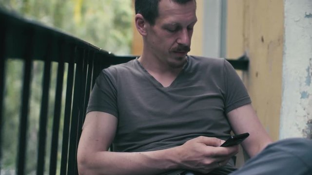 Portrait of a man scrolling in smartphone