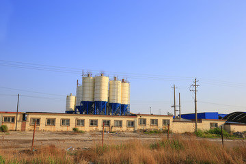 Fototapeta na wymiar Concrete mixing silo, site construction facilities.