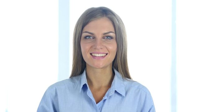 Portrait of Beautiful Smiling Woman Looking at Camera in Office