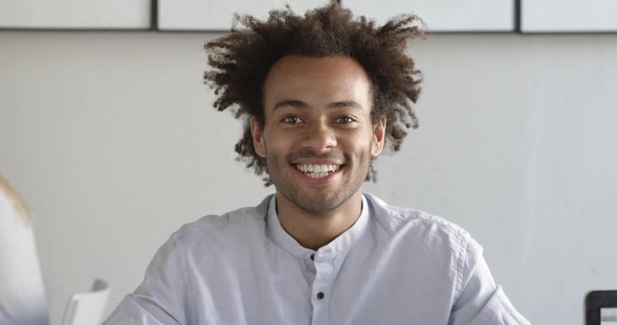 Portrait of happy african student smiling in bright coworking space. Happy to get knowledge. Medium shot. Slow motion.