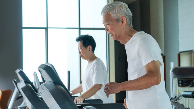 Healthy Asian Senior Couple Exercise Together In Gym Running Treadmill