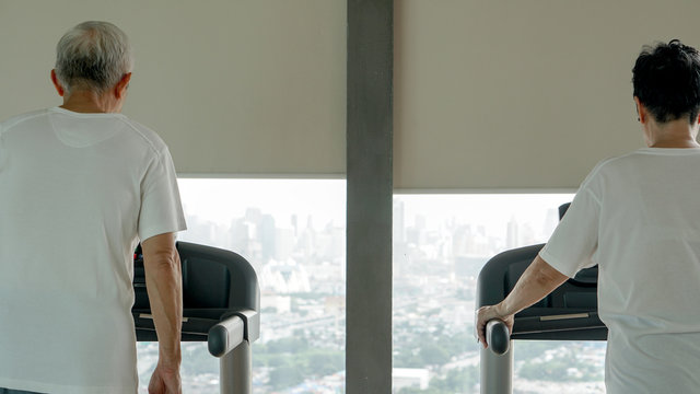 Healthy Asian Senior Couple Exercise Together In Gym Running Treadmill