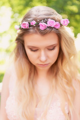 Naklejka premium Portrait of beautiful bride blonde in pink lace dress in the hair ornament handmade. Big facial