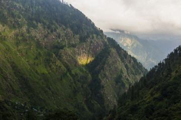 A scenic view sun light on Pir Panjal mountain range before sunset from Rashol village in Himachal Pradesh.