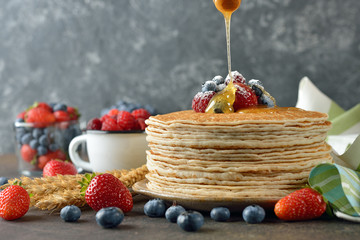 French crepes with berries and honey - obrazy, fototapety, plakaty