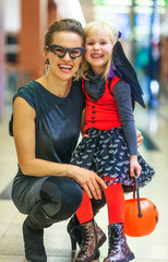happy modern mother and child on Halloween at mall