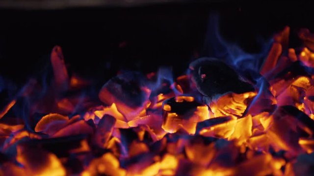 Burning coal. Close up of red hot coal burning in a stove. Slow motion