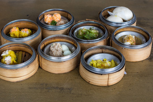 Chinese food : Dim sum, Chinese cuisine prepared as small bite-sized portions of food served in small steamer baskets.