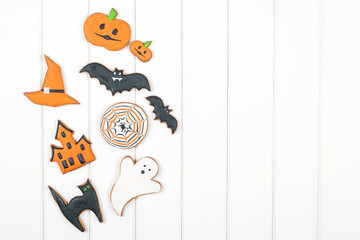 Halloween gingerbread cookies on white wooden table. Top view. Copyspace.