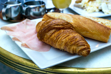 Breakfast with coffee and croissants on table
