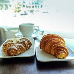 Breakfast with coffee and croissants on table