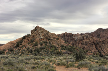 Hikers on Peak of Sandstone Formation
