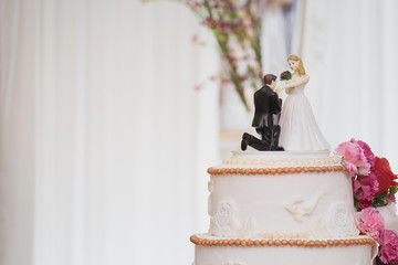 figurines suite decorate on a luxury wedding white cake
