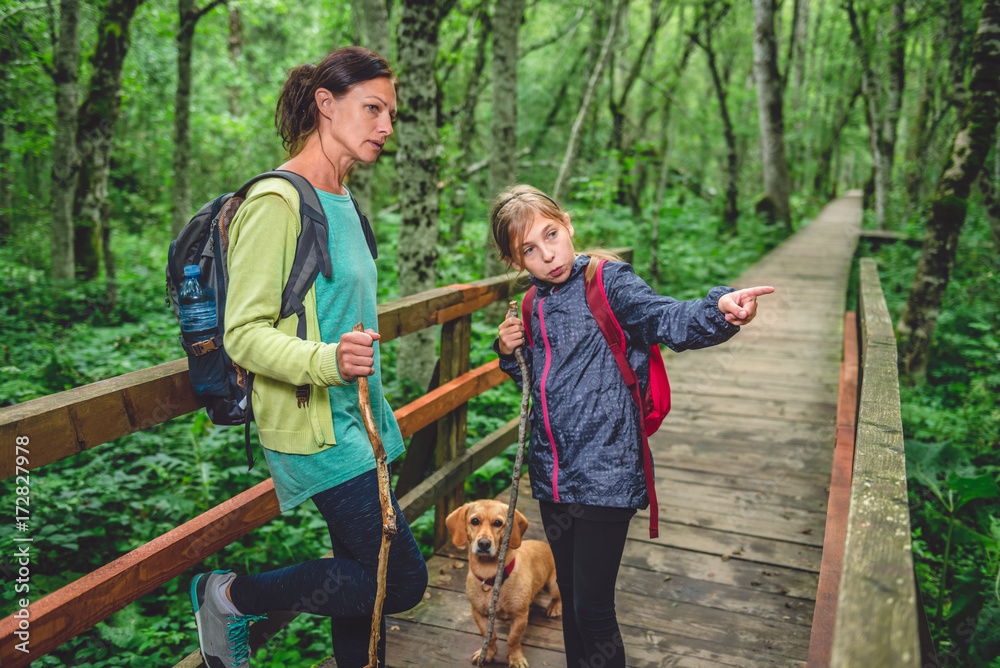 Canvas Prints Mother and daughter with a dog hiking in the forest