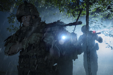 Special Forces soldiers in action. Elite squad moves through fog and smoke.