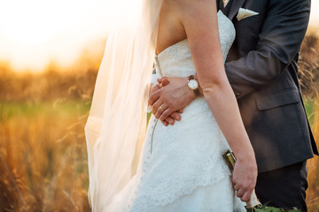 Bride and Groom Embrace in Sunset Light