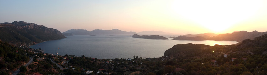 Panoramic dusk view from above with sea and mountains © Artistan