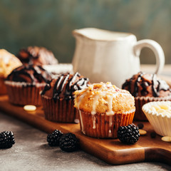 Different homemade muffins with chocolate and berries, selective focus.