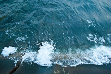 Naklejka na ściany i meble Blue sea, emerald wave beats against the shore
