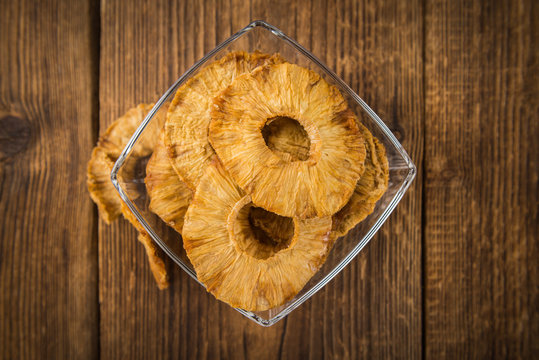 Fresh made Pineapple rings (dried) on a rustic background