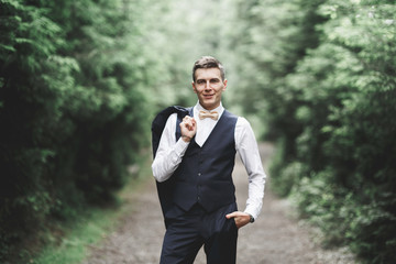 Young handsome man posing on mountain forest