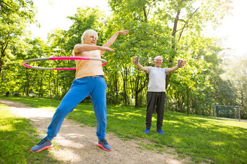 Senior Couple Exercising In Park
