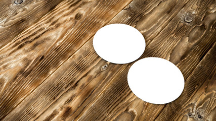 Two single blank beer coasters on a wooden background. Mock up for beer advertising and design