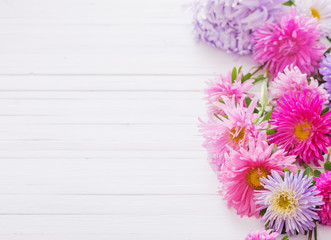 asters on white wooden background