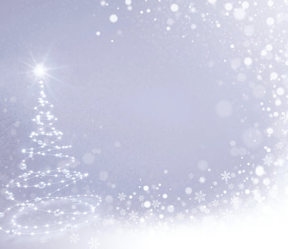 Snowfall on white Christmas tree