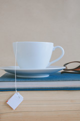 Book glasses and tea on the desk with study and education concept
