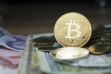 Bitcoin Gold coins placed on banknotes.