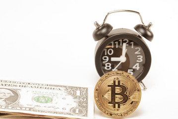 Gold Bitcoin with Banknote Dollar notes suggest a black alarm clock against a white background.