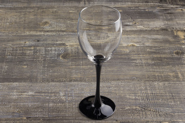 A wine glass on old wooden table. Background
