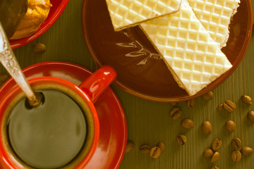Coffee, waffles and cakes on a wooden background