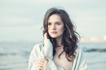 Portrait of a Beautiful Girl with Curly Hair on a Cold Windy Day Outdoors