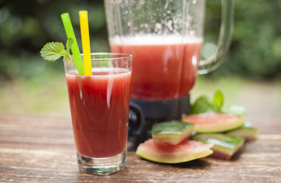 glass of pure watermelon Juice with straw and Shaker on daylight