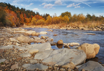 Fototapeta na wymiar Calm mountain stony river in late autumn