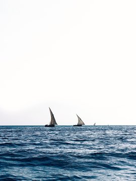 Two Sailboats sailing across the ocean