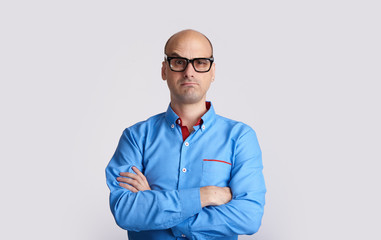 confused bald man wearing glasses isolated