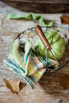 A clew of wool on a metal basket ready to be knitted