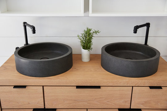Stone vessel sink on oak vanity in rustic farmhouse bathroom