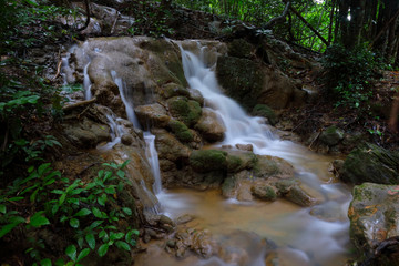 Naklejka na ściany i meble Beautiful waterfall in the deep forest,Pha Tat Waterfall, Kanchanaburi province, Thailand