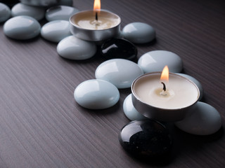 Spa still life concept,Close up of spa theme on wood background with burning candle and bamboo leaf and flower