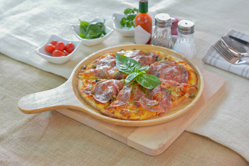 Salame pizza on wooden plate cutting board style