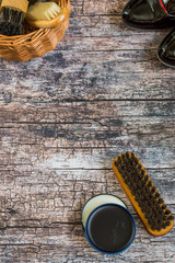 Care products for footwear. Wicker brown basket with shoe brushes, round jars with cream and...