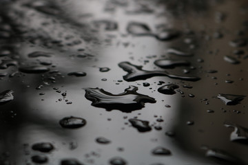      Water drops on a dark metal surface 